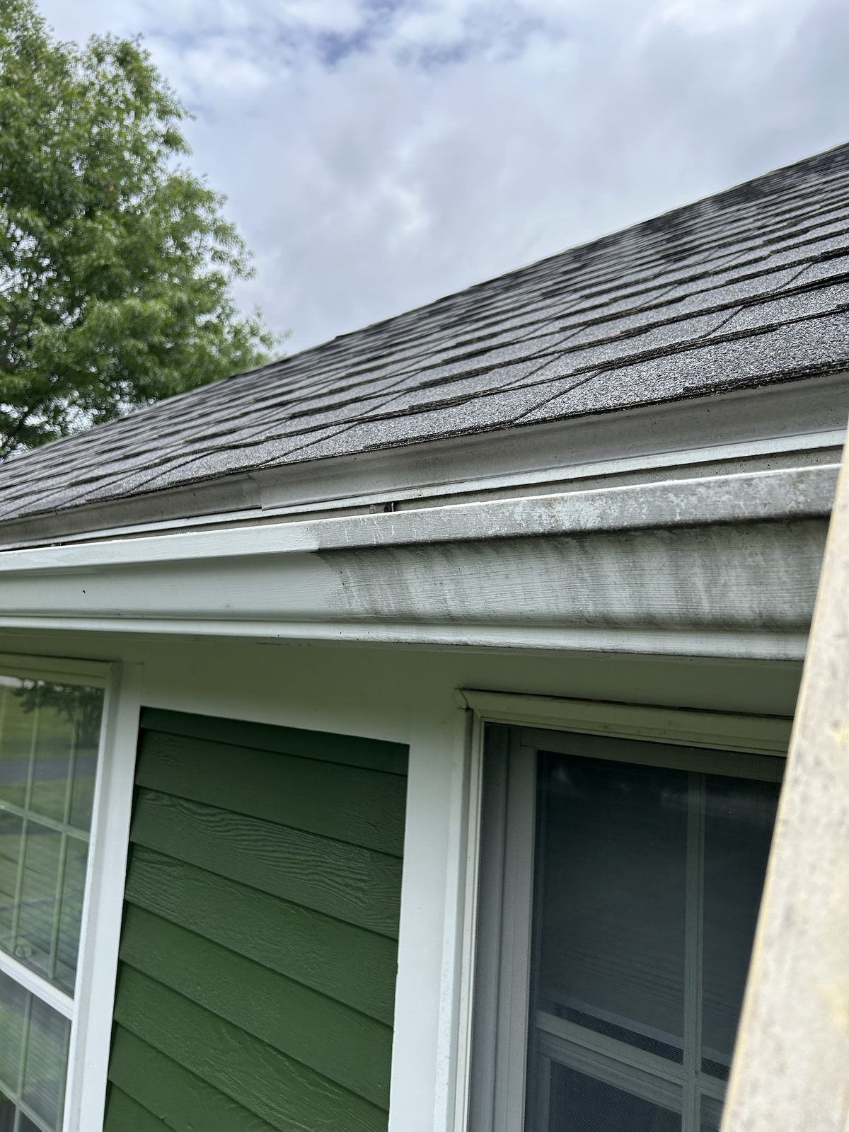 Before — black streaks and grime on the gutter face